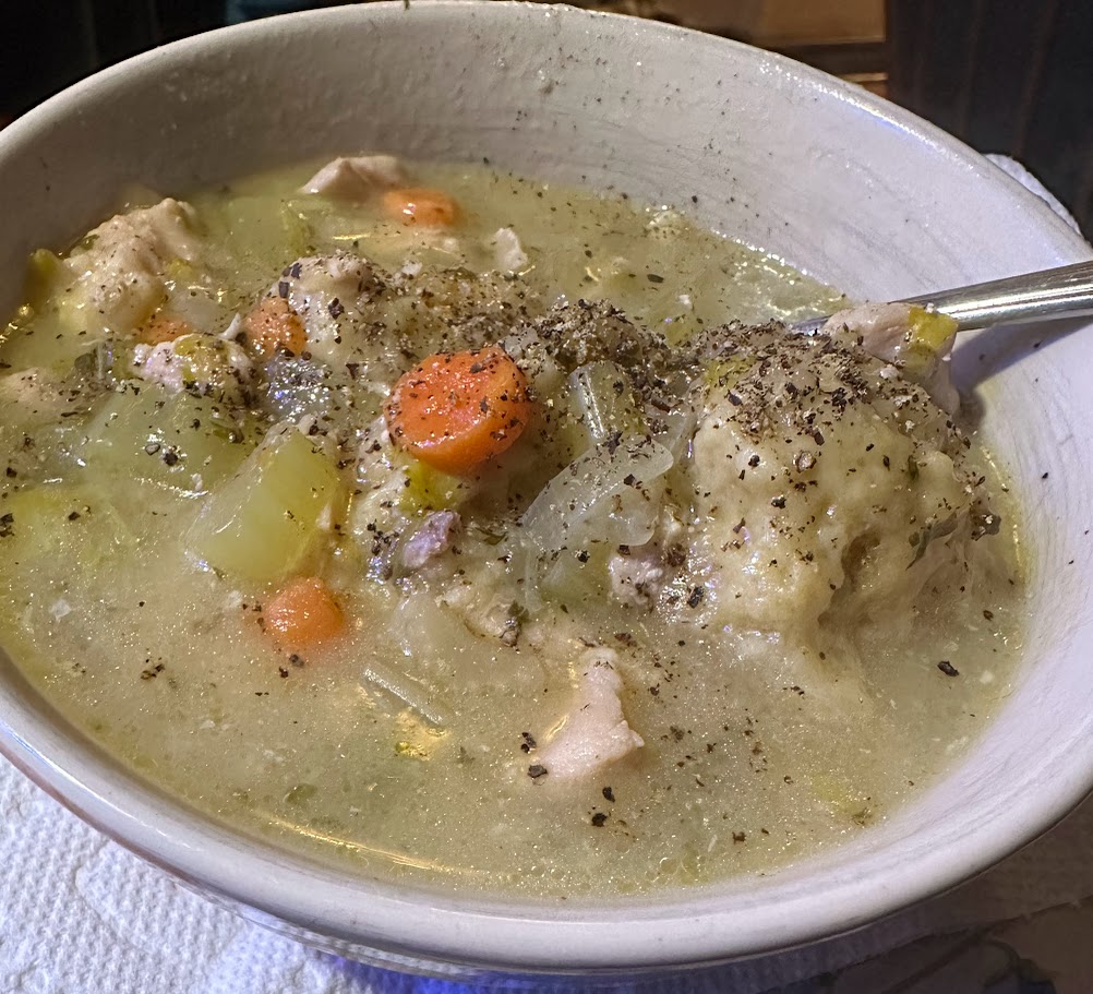 bowl with chicken and dumplins with black pepper